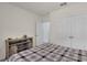 Comfortable bedroom with a modern media console, closet, and a view into the hallway at 1068 Brooklet Dr, Davenport, FL 33837