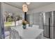 Bright dining area with modern lighting, sliding glass doors, and stainless refrigerator at 1068 Brooklet Dr, Davenport, FL 33837