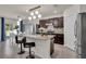 Stunning kitchen featuring stainless steel appliances, dark wood cabinets, and an island with bar seating at 1068 Brooklet Dr, Davenport, FL 33837