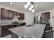 Beautiful kitchen showcasing granite countertops, stainless steel appliances, and dark wood cabinetry at 1068 Brooklet Dr, Davenport, FL 33837