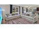 Spacious living room with plush sofas, ample natural light, and stylish decor at 1068 Brooklet Dr, Davenport, FL 33837