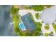 Birds-eye view of a home with a pool, screened enclosure, large roof, and a private dock on a serene lake at 107 Coveridge Ln, Longwood, FL 32779