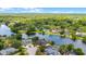 Elevated view of a home on a lake with a pool and nearby homes, providing a glimpse into the serene neighborhood at 107 Coveridge Ln, Longwood, FL 32779
