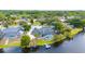 Panoramic aerial shot of a home with a pool, dock, and screened enclosure, nestled on a picturesque lakefront at 107 Coveridge Ln, Longwood, FL 32779