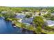 High-angle view of a lakeside property with a pool, private dock, and mature trees, offering privacy and tranquility at 107 Coveridge Ln, Longwood, FL 32779
