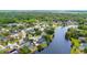 Stunning aerial view of a lakeside community featuring lush trees and beautiful homes with private pools at 107 Coveridge Ln, Longwood, FL 32779