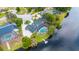 Overhead view of a property featuring a pool with a screened enclosure and a private dock on a tranquil lake at 107 Coveridge Ln, Longwood, FL 32779