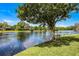 Scenic waterfront backyard with a charming tree swing and a private dock on the lake at 107 Coveridge Ln, Longwood, FL 32779