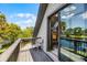 Cozy balcony with views of lake, featuring a desk setup and seating area for outdoor relaxation at 107 Coveridge Ln, Longwood, FL 32779