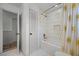 Clean bathroom with white tiled shower featuring tub, stylish curtain, and modern finishes at 107 Coveridge Ln, Longwood, FL 32779