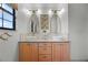 Stylish bathroom featuring double sinks, vintage-style light fixtures, and decorative mirrors at 107 Coveridge Ln, Longwood, FL 32779