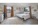 Comfortable bedroom with wood floors, bright light fixture, and natural light from two windows at 107 Coveridge Ln, Longwood, FL 32779