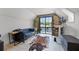 Cozy bonus room with a comfortable blue leather couch, a cowhide rug, and a scenic view at 107 Coveridge Ln, Longwood, FL 32779