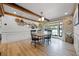 Charming dining room with wood beams, unique chandelier, and large windows at 107 Coveridge Ln, Longwood, FL 32779