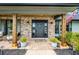 Inviting entryway featuring a brick porch, decorative wreath, and stylish outdoor decor at 107 Coveridge Ln, Longwood, FL 32779
