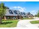 Beautiful brick home with an inviting front porch, manicured lawn, and circular driveway at 107 Coveridge Ln, Longwood, FL 32779