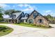 Beautiful brick home featuring manicured landscaping, dormer windows, and a welcoming front lawn at 107 Coveridge Ln, Longwood, FL 32779
