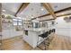 Bright kitchen with wooden beam, island and stainless steel sink with backyard view at 107 Coveridge Ln, Longwood, FL 32779