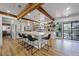 Open kitchen with island, breakfast bar, modern lighting, and wood beam at 107 Coveridge Ln, Longwood, FL 32779