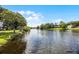 Beautiful lake view surrounded by lush greenery on a sunny day, creating a serene and inviting atmosphere at 107 Coveridge Ln, Longwood, FL 32779