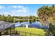 Serene lake view featuring a private dock, lush greenery, and waterfront homes in a peaceful community at 107 Coveridge Ln, Longwood, FL 32779