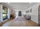 Spacious living room featuring wood floors, stylish wallpaper, and a vintage piano at 107 Coveridge Ln, Longwood, FL 32779