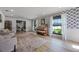 Bright living room with large windows, artistic wallpaper, and stylish decor at 107 Coveridge Ln, Longwood, FL 32779