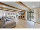 Bright living room with wooden beams, brick fireplace, and large sliding glass doors to the outside at 107 Coveridge Ln, Longwood, FL 32779