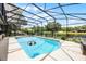 Enclosed pool area with a large pool, lounge chairs, and lush landscaping at 107 Coveridge Ln, Longwood, FL 32779