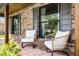 Cozy front porch featuring comfortable chairs, brick flooring, and stylish architectural details at 107 Coveridge Ln, Longwood, FL 32779