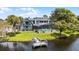 Backyard view features a screened pool, fenced yard, lush greenery, and a private dock at 107 Coveridge Ln, Longwood, FL 32779