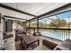Inviting screened-in patio with stylish seating area and view of the sparkling pool and landscaped backyard at 107 Coveridge Ln, Longwood, FL 32779