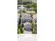Stunning aerial view of home showcasing solar panels, landscaping, and water view with fountain at 1090 Wildmeadow Run, Winter Park, FL 32792