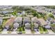 An aerial view shows well-maintained homes and properties in the neighborhood and the beautiful community pond at 1090 Wildmeadow Run, Winter Park, FL 32792