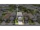 An aerial view shows well-maintained homes and properties in the neighborhood and the beautiful community pond at 1090 Wildmeadow Run, Winter Park, FL 32792