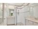 Bathroom with double sinks and seamless glass shower, featuring white cabinets and tile flooring at 1090 Wildmeadow Run, Winter Park, FL 32792