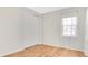 Bright bedroom with wood flooring, sliding door closet, and sunny window with sheer curtains at 1090 Wildmeadow Run, Winter Park, FL 32792