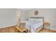 Bedroom view showcasing wood floors, neutral decor, and a doorway to the en suite bathroom at 1090 Wildmeadow Run, Winter Park, FL 32792