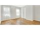 Bedroom with light-colored walls, wood flooring, two windows with sheer curtains, and a closet at 1090 Wildmeadow Run, Winter Park, FL 32792