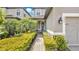 Inviting front entrance with lush landscaping, paver walkway, and charming front door at 1090 Wildmeadow Run, Winter Park, FL 32792