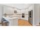 Bright kitchen with white cabinetry, stainless steel appliances, and quartz countertops at 1090 Wildmeadow Run, Winter Park, FL 32792