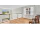 Loft area with wood floors, natural light, and decorative chairs, overlooking the lower floor at 1090 Wildmeadow Run, Winter Park, FL 32792