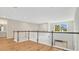 Second story loft space featuring a custom decorative wall, wood flooring, and a bright window at 1090 Wildmeadow Run, Winter Park, FL 32792