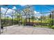 Large screened-in patio features brick flooring with tranquil views of garden at 1090 Wildmeadow Run, Winter Park, FL 32792
