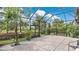Screened-in lanai offering brick flooring and relaxing views of the landscaped backyard at 1090 Wildmeadow Run, Winter Park, FL 32792