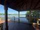 Breathtaking view from covered wooden pavilion of water, trees, and blue sky at 1090 Wildmeadow Run, Winter Park, FL 32792