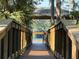 Scenic view from a wood planked pier to a peaceful lake under a blue sky through the foliage at 1090 Wildmeadow Run, Winter Park, FL 32792