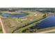 Panoramic aerial view of the golf course, water features, and lush landscape of the community at 1121 Blue Jay Dr, Davenport, FL 33837
