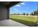 Inviting back patio with gorgeous views of the lake and palm trees, perfect for relaxing and enjoying nature at 1121 Blue Jay Dr, Davenport, FL 33837