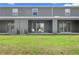 Cozy back patio with sliding glass doors, lawn, and view perfect for outdoor relaxation at 1121 Blue Jay Dr, Davenport, FL 33837
